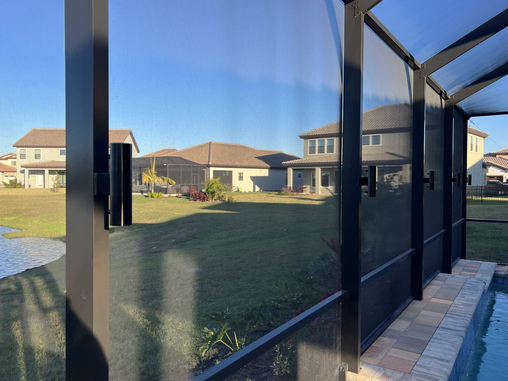 Close-up of concealed flush-mounted LED sconce integrated into pool cage post