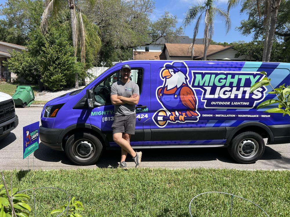 Mighty Lights owner at the service van ready to diagnose dim and flickering landscape lighting in Tampa Bay